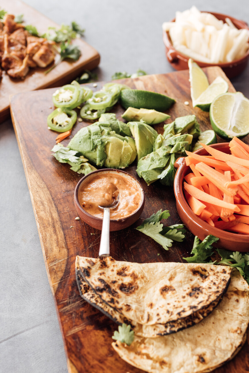 limey chicken tacos on serving tray with ingredients