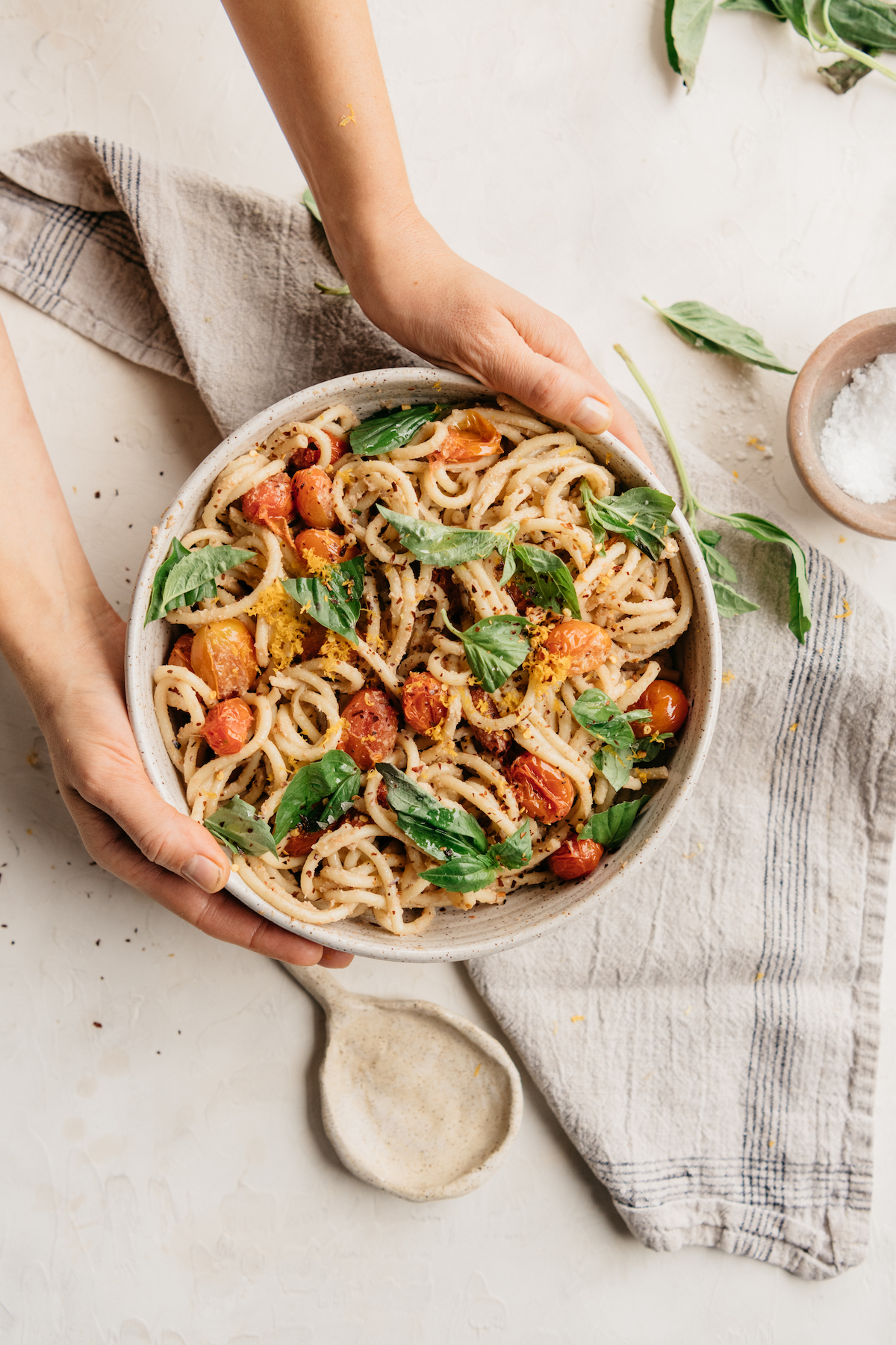 creamy vegan bucatini pasta with roasted tomatoes and basil, easy plant-based dinner